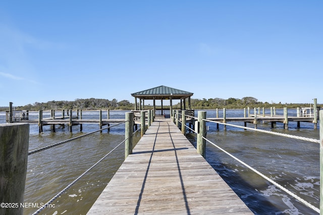 view of dock with a gazebo and a water view