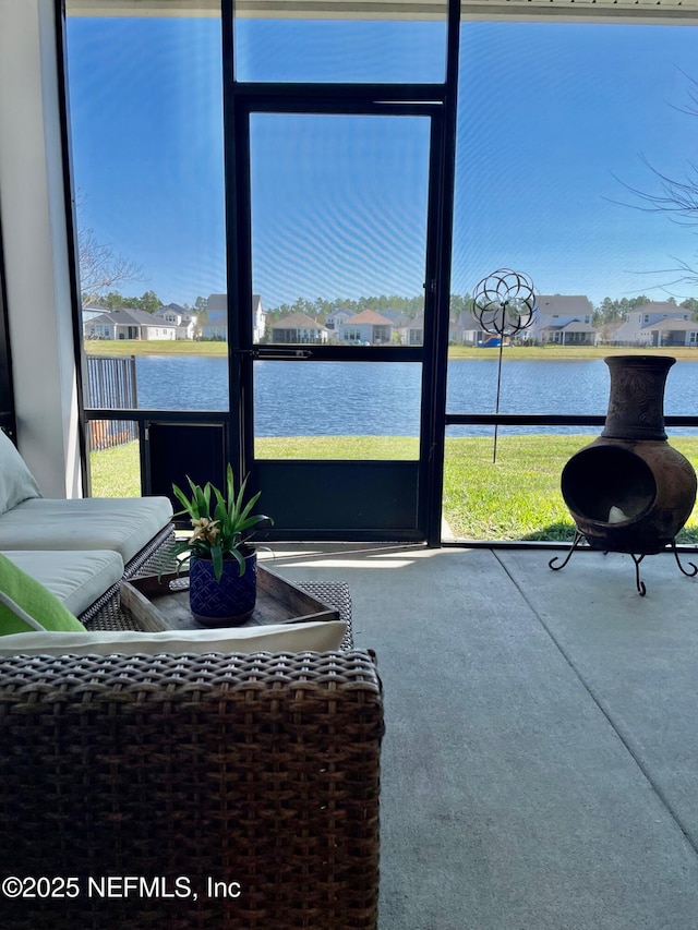 sunroom / solarium featuring a water view and a healthy amount of sunlight