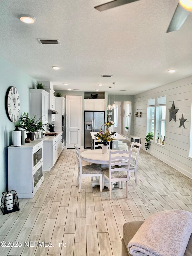 dining space featuring a textured ceiling