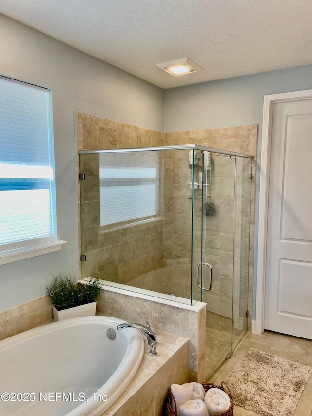 bathroom featuring separate shower and tub