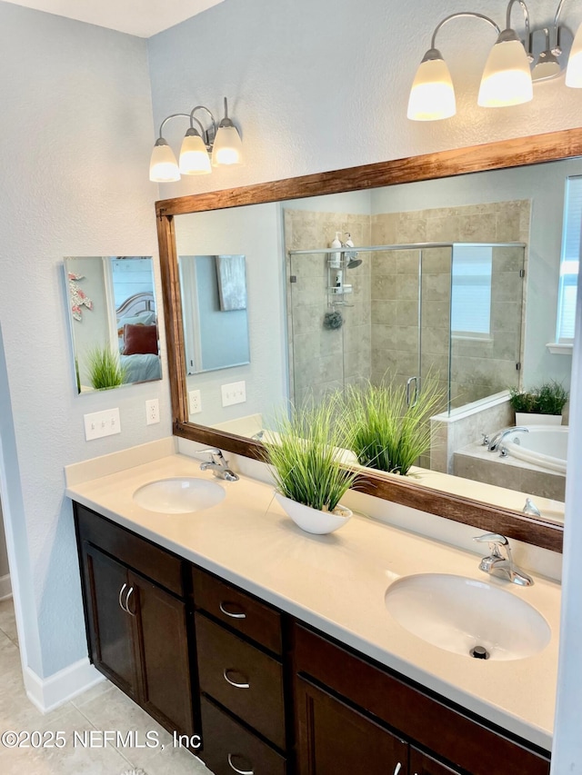 bathroom featuring independent shower and bath, vanity, and tile patterned floors