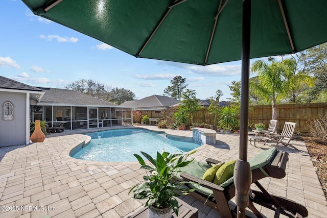 view of swimming pool featuring a patio area and a sunroom