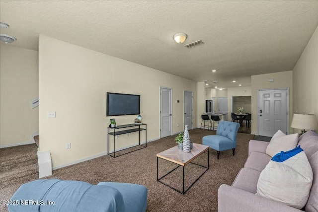 living room featuring carpet flooring and a textured ceiling