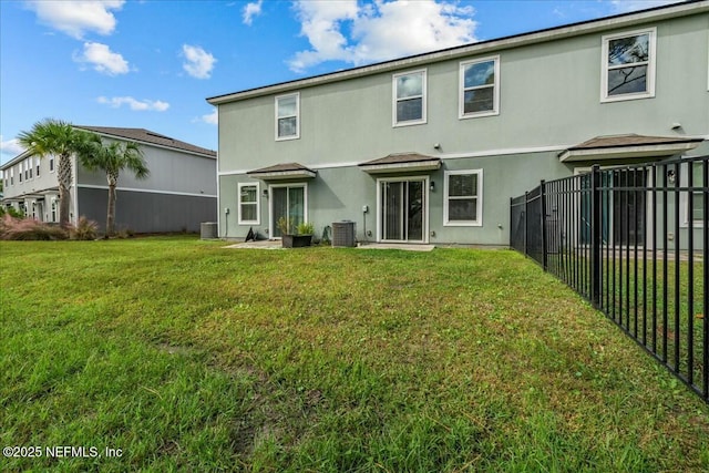 back of property featuring a yard and central AC unit