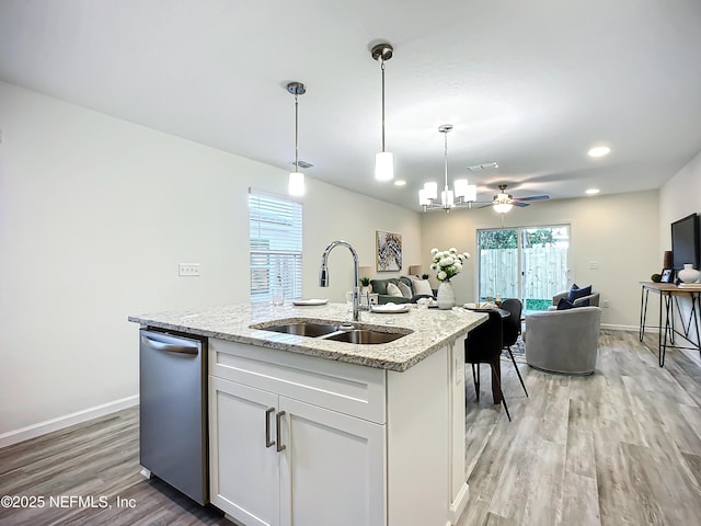 kitchen with sink, decorative light fixtures, dishwasher, light hardwood / wood-style floors, and white cabinets