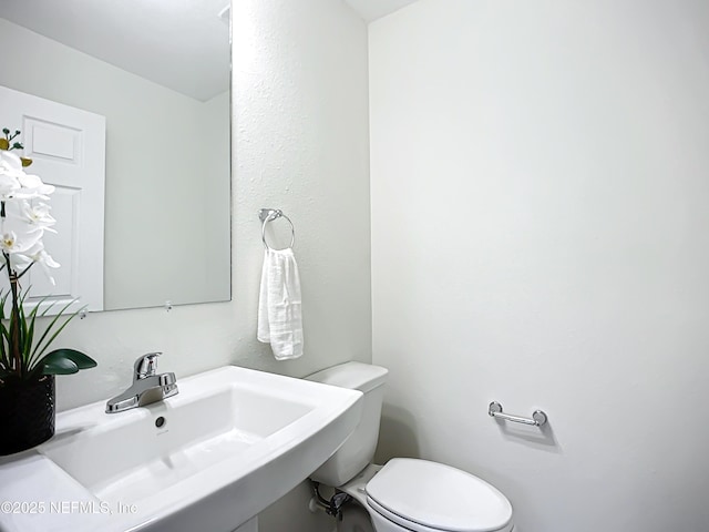 bathroom with sink and toilet