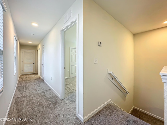 hallway with light colored carpet