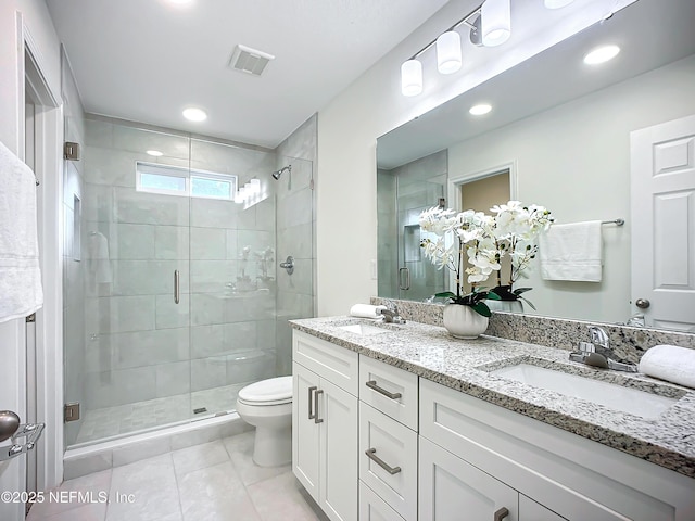 bathroom featuring vanity, an enclosed shower, tile patterned floors, and toilet