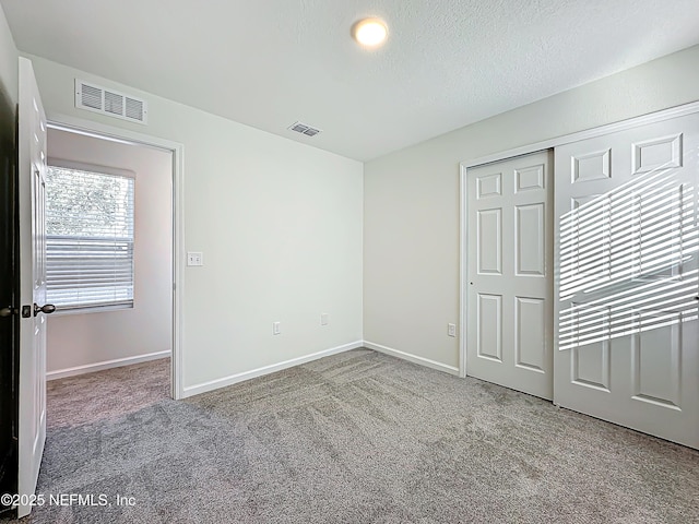 unfurnished bedroom with carpet floors and a closet