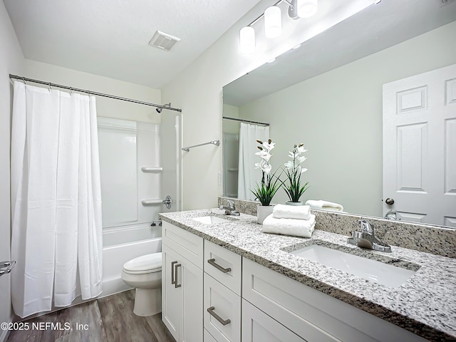 full bathroom featuring shower / tub combo with curtain, vanity, wood-type flooring, and toilet