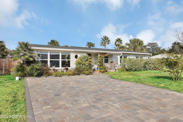 ranch-style home with a front lawn