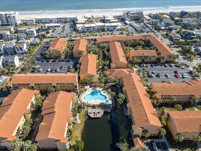 bird's eye view featuring a water view and a beach view