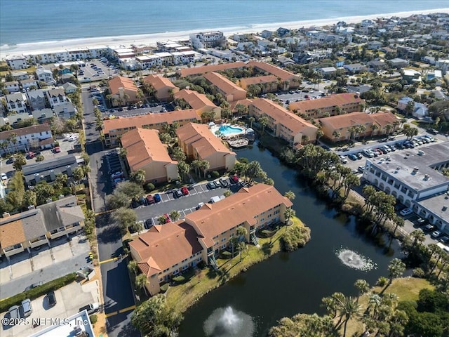 bird's eye view featuring a water view and a beach view