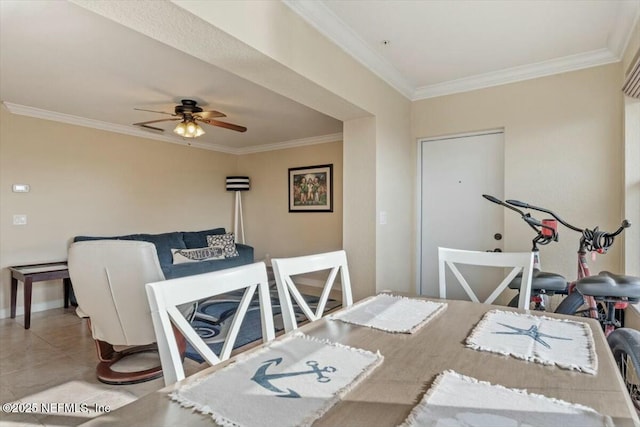 dining area with crown molding, ceiling fan, and tile patterned floors