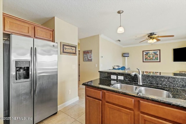 kitchen with sink, stainless steel fridge with ice dispenser, a textured ceiling, light tile patterned floors, and ornamental molding