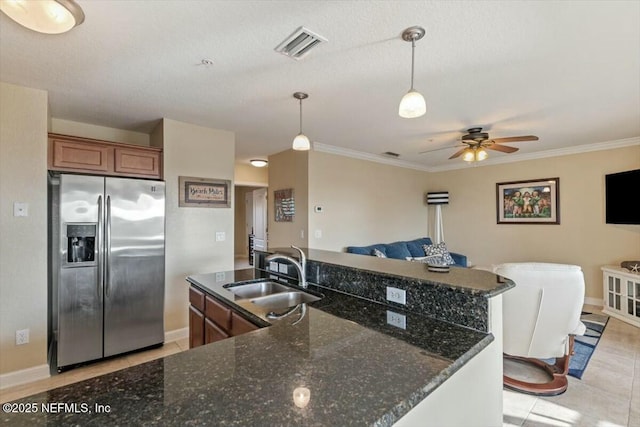 kitchen featuring stainless steel fridge with ice dispenser, decorative light fixtures, sink, and light tile patterned floors