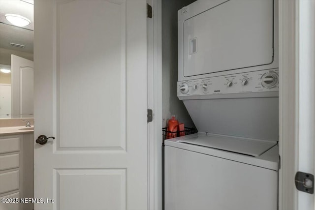 clothes washing area with stacked washer and clothes dryer