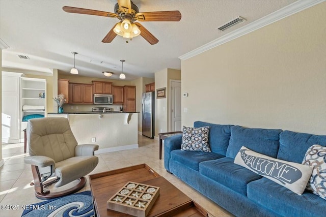 living room with light tile patterned floors, ornamental molding, a textured ceiling, and ceiling fan