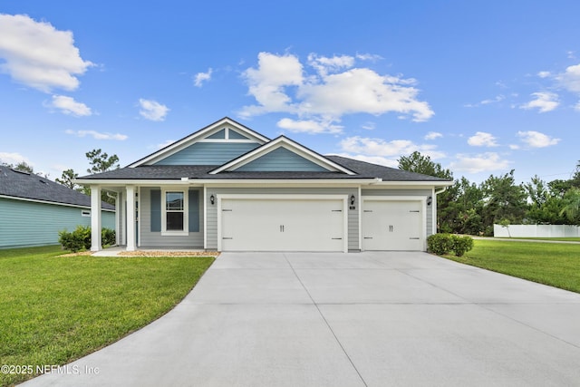 view of front of house with a garage and a front lawn