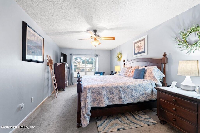 carpeted bedroom with ceiling fan and a textured ceiling