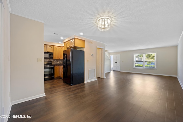 unfurnished living room with an inviting chandelier, dark wood-type flooring, and a textured ceiling