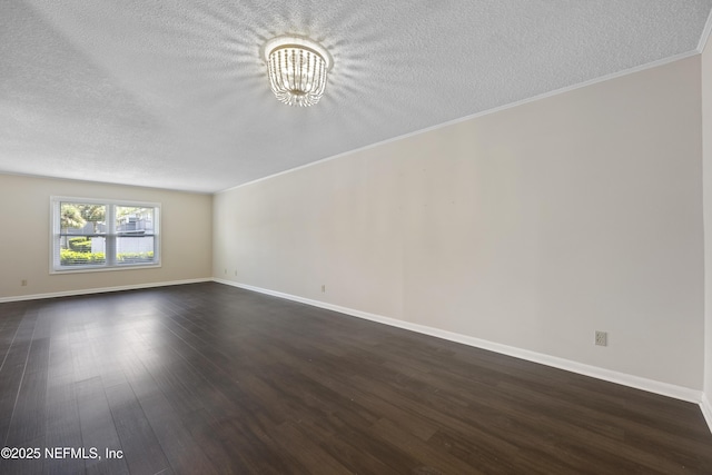 empty room with dark hardwood / wood-style flooring, a notable chandelier, crown molding, and a textured ceiling