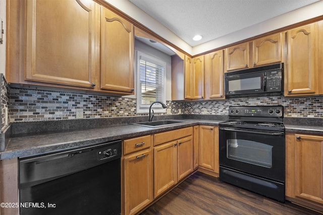 kitchen with sink, dark hardwood / wood-style floors, tasteful backsplash, black appliances, and a textured ceiling