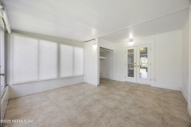 unfurnished sunroom with french doors