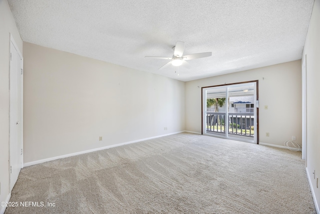 carpeted empty room featuring ceiling fan and a textured ceiling