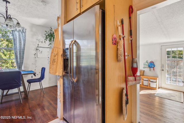 kitchen featuring dark wood-type flooring, a chandelier, a textured ceiling, and stainless steel refrigerator with ice dispenser