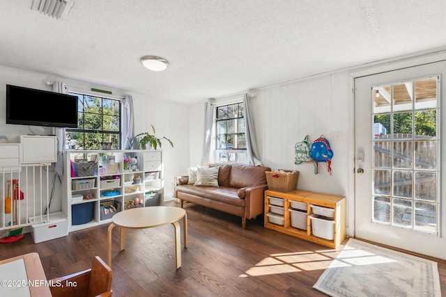 sitting room with dark hardwood / wood-style floors and a textured ceiling