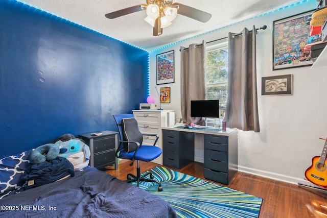 office area featuring ceiling fan, dark wood-type flooring, and a textured ceiling