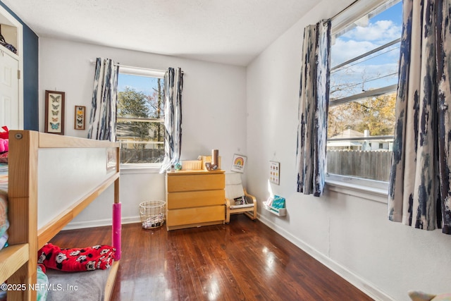 bedroom with dark wood-type flooring