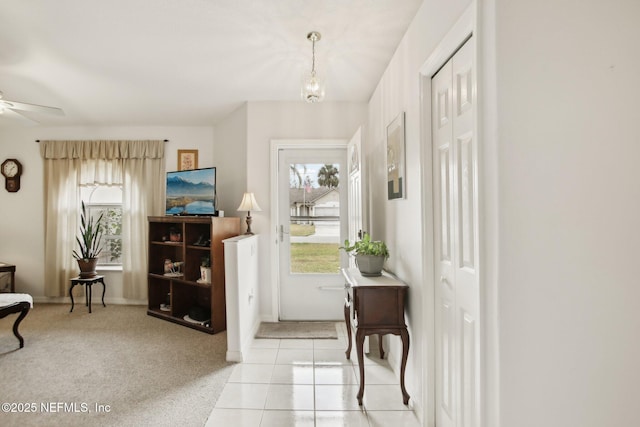 foyer entrance featuring light carpet, a wealth of natural light, and ceiling fan