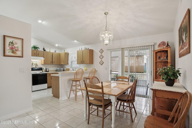 dining space with a wealth of natural light, vaulted ceiling, a chandelier, and light tile patterned flooring