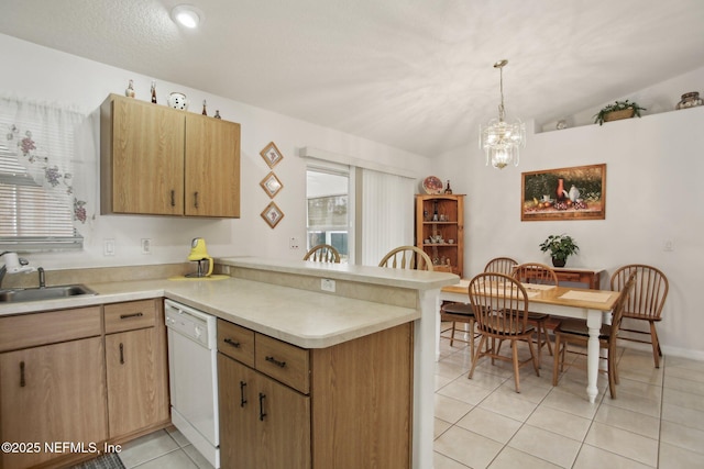 kitchen with vaulted ceiling, dishwasher, sink, hanging light fixtures, and kitchen peninsula