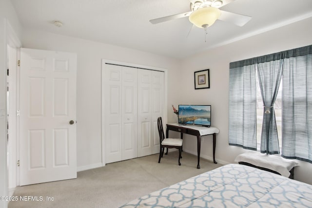 bedroom with ceiling fan, a closet, and light carpet