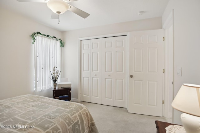 bedroom featuring light carpet, a closet, and ceiling fan