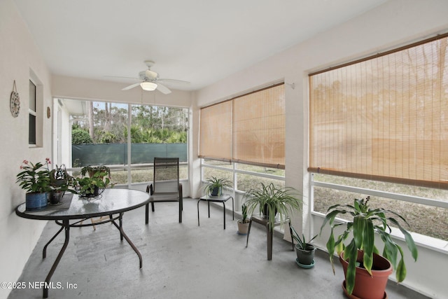 sunroom / solarium featuring ceiling fan