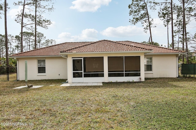 back of property featuring a yard and a sunroom