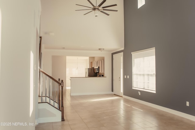 tiled foyer entrance with a towering ceiling