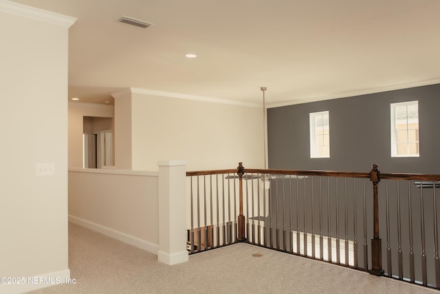 hall featuring light colored carpet and ornamental molding