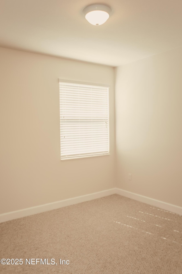 carpeted spare room featuring a healthy amount of sunlight