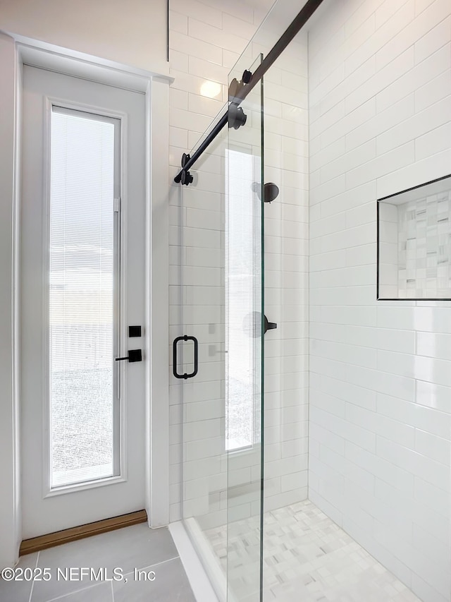 bathroom featuring a shower with door