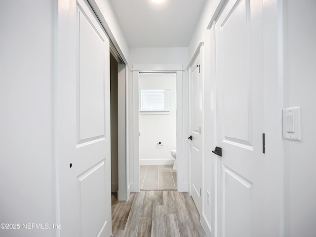 corridor with light wood-type flooring