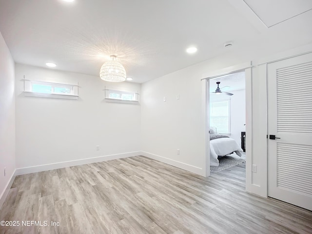 basement with light hardwood / wood-style floors