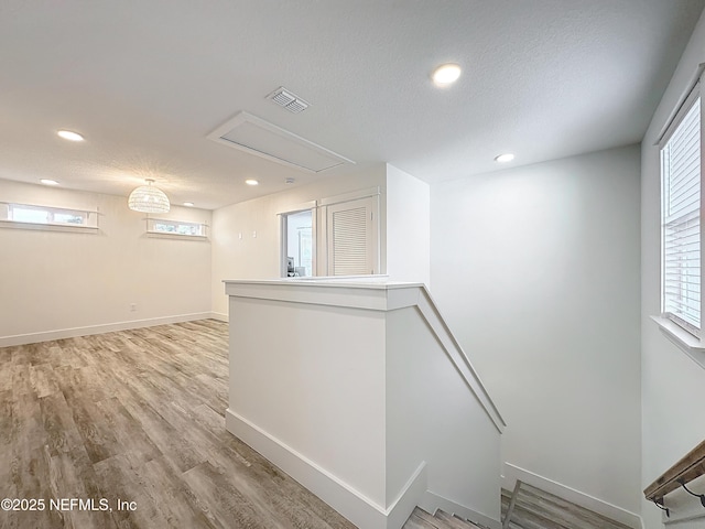 interior space with light hardwood / wood-style floors and a textured ceiling