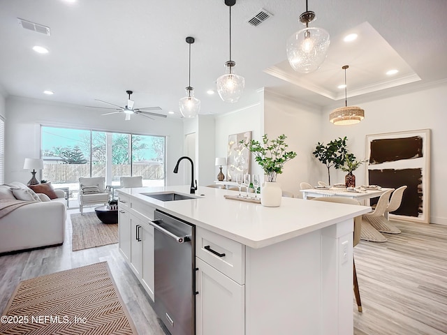 kitchen featuring sink, hanging light fixtures, white cabinets, and dishwasher