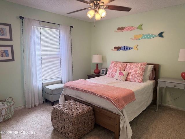 carpeted bedroom with ceiling fan and a textured ceiling