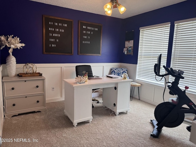 carpeted home office with a textured ceiling